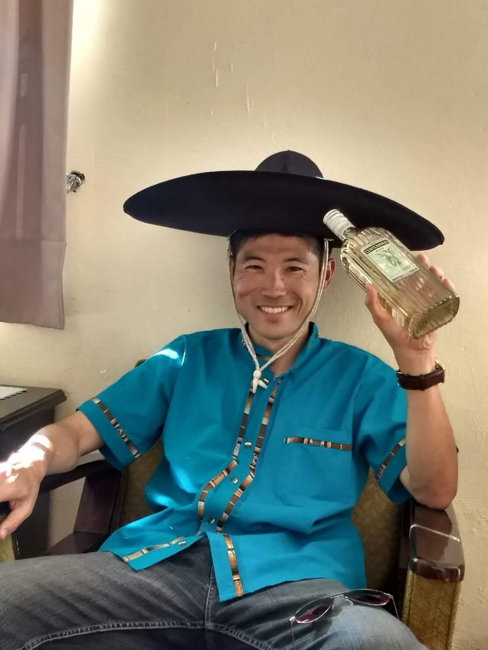 Isao Iwasaki, a Mexican tourist guide, poses with a hat and tequila